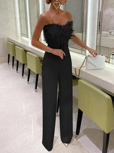 Sleeveless strapless black jumpsuit with feather trim and matching waist belt