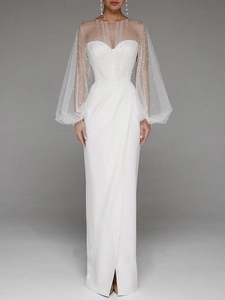 Detail of white evening dress with elegant sheer mesh shawl and pearl decorations