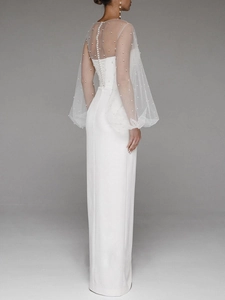 Close-up of white pearls on sheer cape and lace-up back detail of formal dress