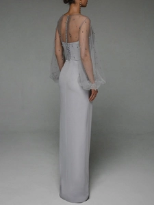 Macro shot of elegant back detail with pearls and lace-up closure on the evening dress