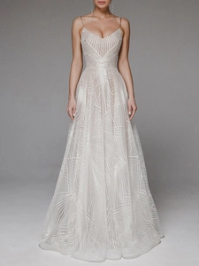 Macro shot of V-neck white gown featuring shimmering radial geometric glitter patterns