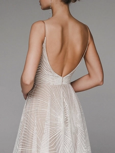Detail of elegant open back dress with silver sequin patterns and thin shoulder straps