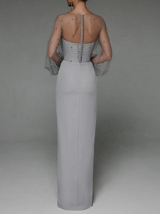 Close-up of elegant grey evening dress with vertical pearl buttons on sheer tulle back