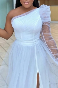 Detail of elegant white one-shoulder mesh dress with layered tulle and high side slit