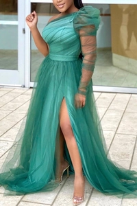 Detail of emerald green off-shoulder tulle gown with single puff sleeve and high slit