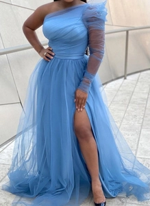 Detail view of light blue mesh evening gown featuring one-shoulder design and high slit