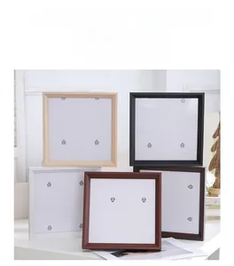 Stack of five minimalist square picture frames in assorted wood and neutral finishes