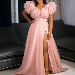 Detail of pink mesh maxi dress featuring ruffled sleeves and a sexy high slit design