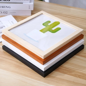 Stack of square wooden photo frames in natural wood, reddish brown, white and black colors