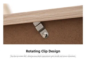 Detail of the 360-degree rotating metal clip on the back of a wooden photo frame