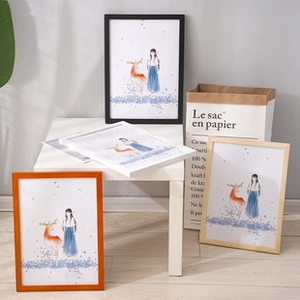 Detail of Nordic solid wood frames in black, white, orange and natural oak finishes
