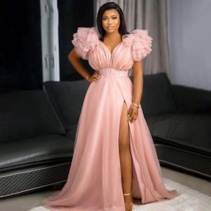Close-up of pink V-neck tulle dress featuring ruffled tiered sleeves and a high slit skirt