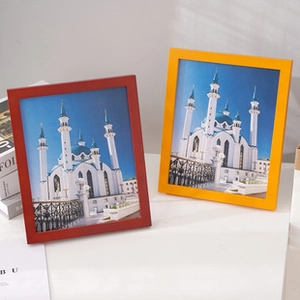 Detailed view of red and yellow solid wood frames on table with natural lighting