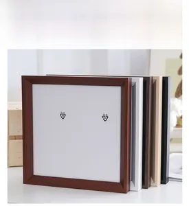 Close-up of square photo frames in various wood grain finishes and colors with white mats