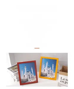 Detail showing a minimalist set of bright red and yellow pine wood frames on a desk