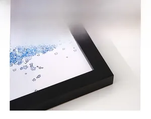 Macro shot of 90 degree seamless joint on a black wooden frame with minimalist floral art