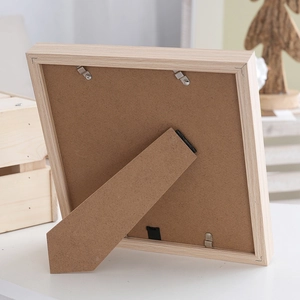 Square wood frame back view with adjustable stand and metal clips on natural timber base