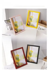 Detail view of modern rectangular photo frames in pink, yellow, red, and black finishes