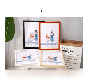 Close-up of pine wood photo frames in various colors with Nordic art illustrations