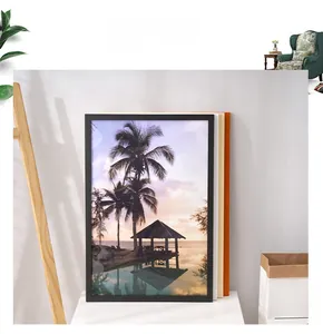 Close-up of minimalist black wood frame with tropical beach landscape art on wall