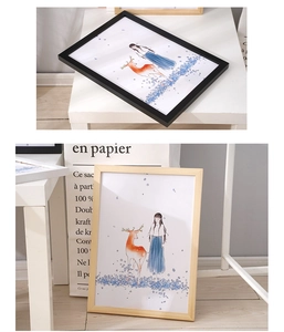 Detail of pine wood frame in black and natural finish with art illustration insert
