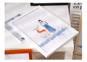 Detail of a white minimalist pine frame with a warm illustration of a girl and deer