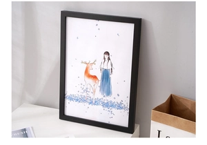 Detail of minimalist black pine wood frame featuring a healing style deer illustration