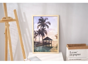 Modern 16-inch solid wood frame with tropical palm tree sunset print on a white tabletop