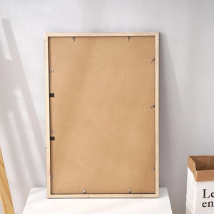 Rear view of a solid pine wood picture frame showing sturdy metal clips and backboard