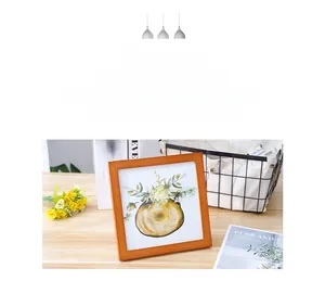 Detail of square light wood frame with floral art print in Nordic minimalist interior style