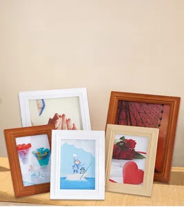 Detail of minimalist solid wood photo frames in various finishes with 3D carved textures