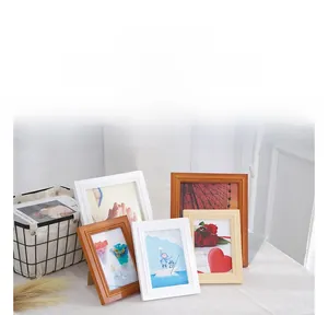Detail of Nordic solid wood frames in white and oak with artistic floral and landscape prints