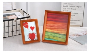 Close-up of Nordic style wooden 3D photo frames on a warm neutral tabletop setting