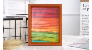 Close-up of a solid wood picture frame with a vibrant abstract gradient art print