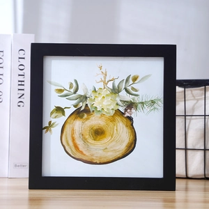 Square black picture frame with tree ring watercolor art in a minimalist Nordic style