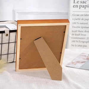 Back view of solid wood picture frame with adjustable stand and metal clips