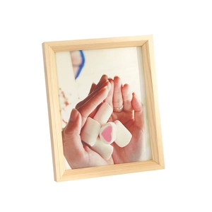 Minimalist solid wood picture frame in light pine finish with natural wood grain texture