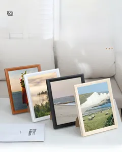 Detailed view of assorted solid wood photo frames in various colors with backrest stand
