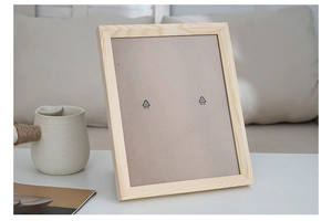 Detail view of natural solid wood photo frame back with grey fiberboard and fasteners
