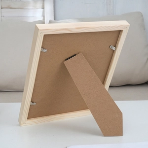 Back view of minimalist natural wood photo frame with adjustable stand and metal clips