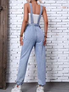 Women's light blue wash denim overalls featuring thin straps and elastic ankle cuffs