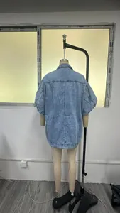 Detail view of back panel seams and oversized drop shoulder of light blue denim vest
