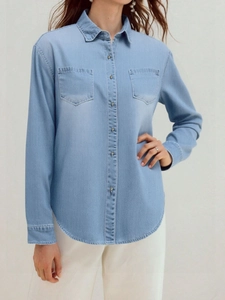 Women casual loose light blue denim shirt jacket with dual chest pockets and metal buttons