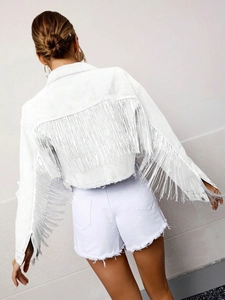 Close-up of white denim jacket featuring long fringe tassels on back and sleeves