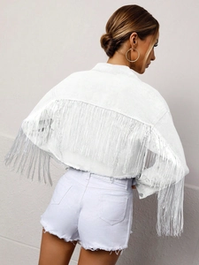 Detailed back view of white denim jacket with long fringe tassels on sleeves and back