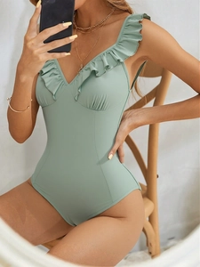 Chic mint green one-piece swimsuit with ruffle trim and flattering ruched details