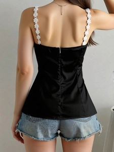 Women's black satin camisole with white floral lace straps and a back invisible zipper
