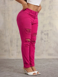 Fuchsia slim-fit high-waisted distressed denim jeans with large ripped details and raw hem