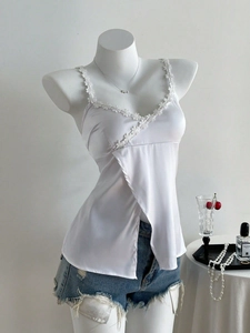 White satin V-neck camisole with lace flowers and overlapping split hem detail