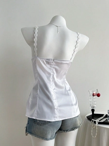 Elegant white satin camisole with floral lace straps and back zipper on mannequin